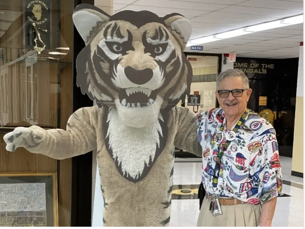 Mr. Moroz poses with a stand-up of Benny the Bengal used to advertise different events at school.